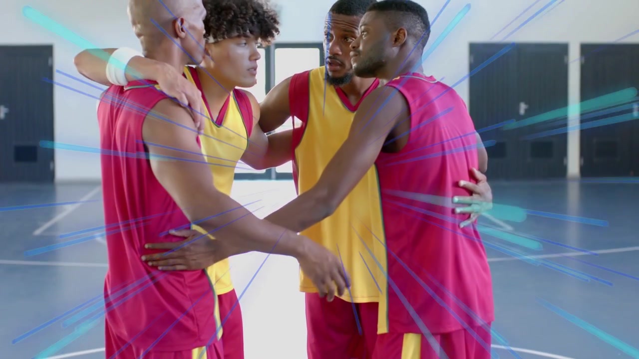 Male players circling ball then forming huddle for pre-play strategy, streaks overlaying players
