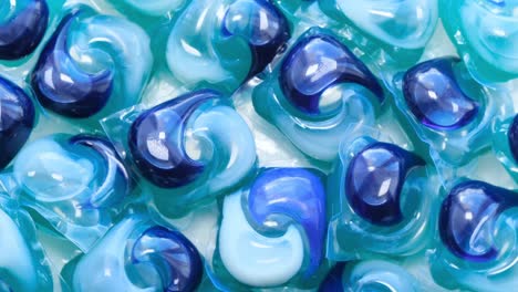 colorful capsules with washing powder a pile of several washing capsules rotates tablets for washing