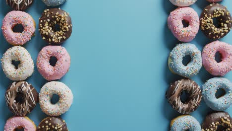 video of donuts with icing on blue background