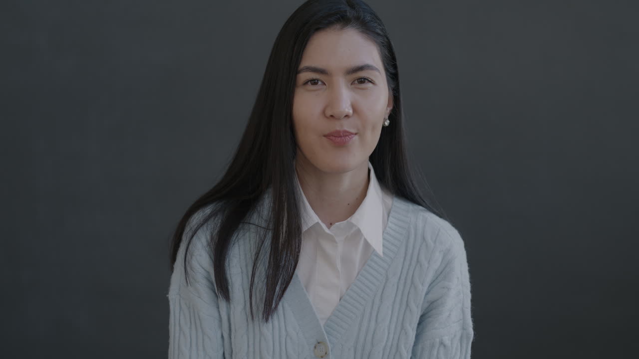 Surprised Woman in Light Blue Cardigan