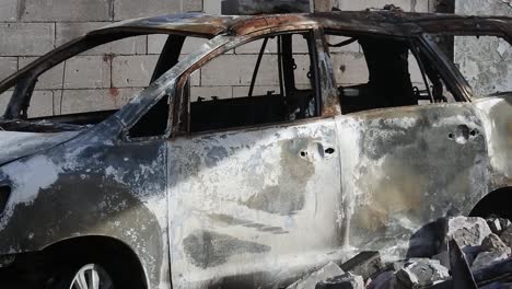 pan shot of a car caught on fire as a result of an exploding fuel oil storage tank near a densely populated residential area in plumpang, north jakarta, indonesia