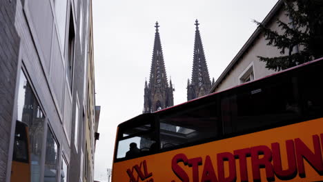 a unique perspective of cologne cathedral's iconic twin spires framed by residential buildings, blending history with modern urban life.
