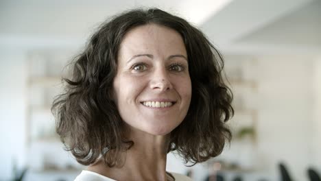 closeup shot of beautiful mature woman posing at office