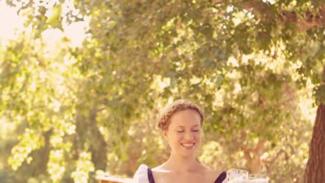 Happy-waitress-holding-pints-of-beer-