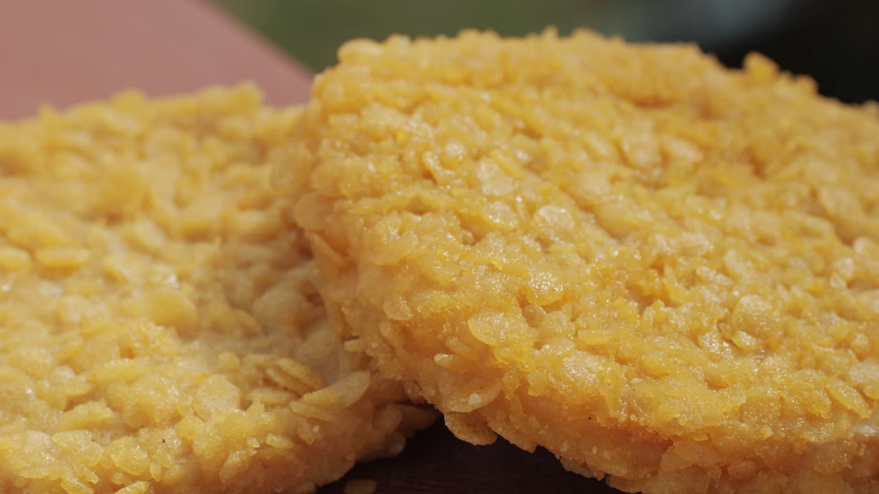 Delicious fresh crispy chicken nuggets on a dark concrete background. Unhealthy food, fast food. High quality 4k footage