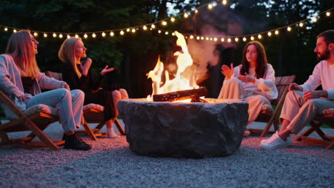 friends enjoying a campfire in the evening