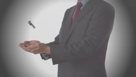 animation of zigzag lines over businessman throwing and catching nut and bolt, on grey background