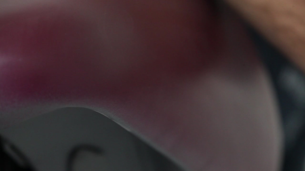 A people is making a custom painting for his motorcycle in his garage