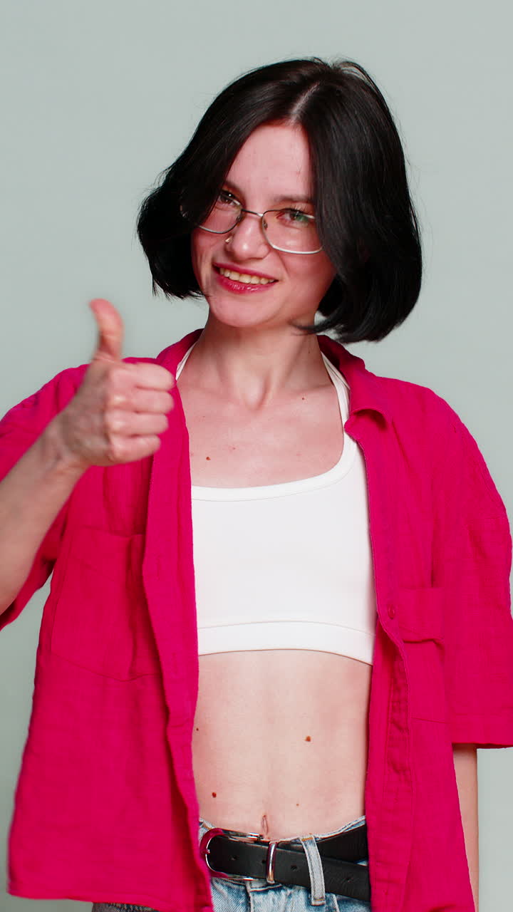 Young woman celebrating win with joyful smile expressing happiness success achievement excitement