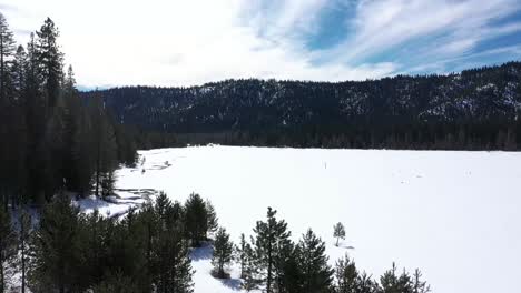 Decke-Aus-Frisch-Gefallenem-Schnee-Auf-Einem-Offenen-Feld-Mit-Einem-Kleinen-Bach-Und-Bäumen