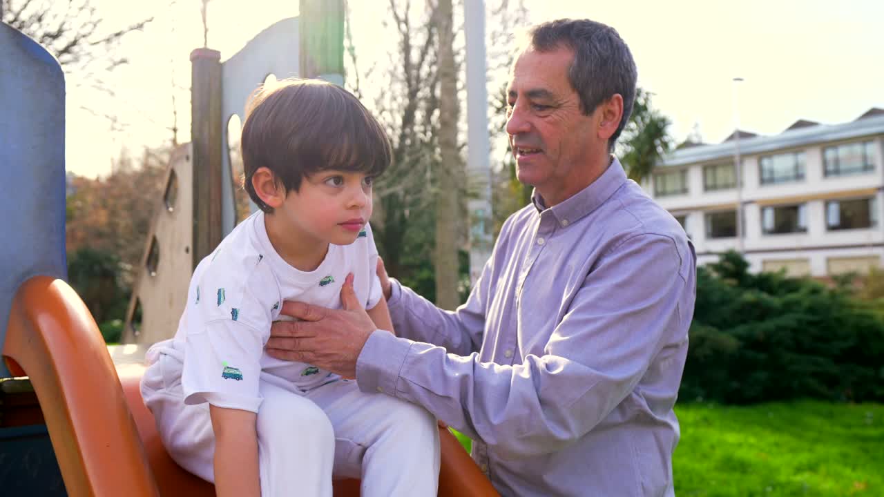 Grandparent and grandchild playing at the playground