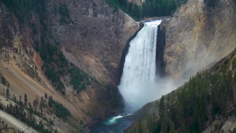 the grand canyon of yellowstone national park the lower falls thunder as mist rises above the bottom of the waterfall