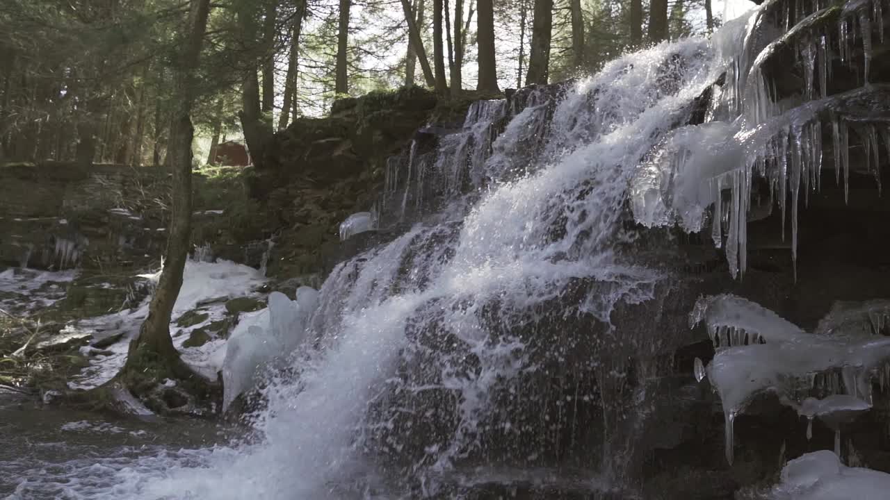 Waterfall with ice formations in the middle of a forest in central Pennsylvania - Rosecrans Falls