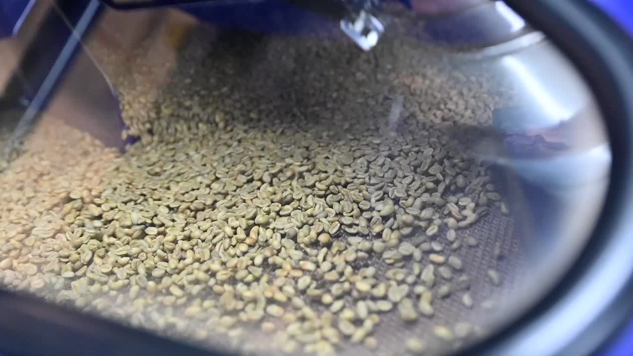 Tampilan dekat biji kopi hijau yang belum disangrai sedang dikeringkan dalam wadah, biji kopi mentah.