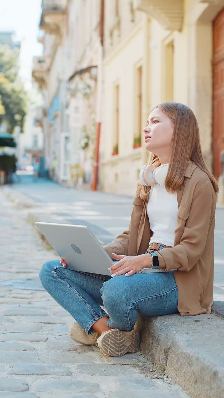 Displeased young woman using laptop working loses becoming surprised sudden lottery result outdoors