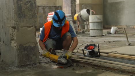 construction worker using angle grinder