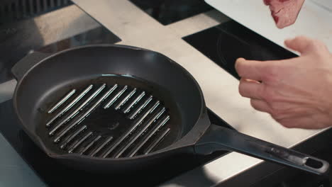 spreading oil on grill pan