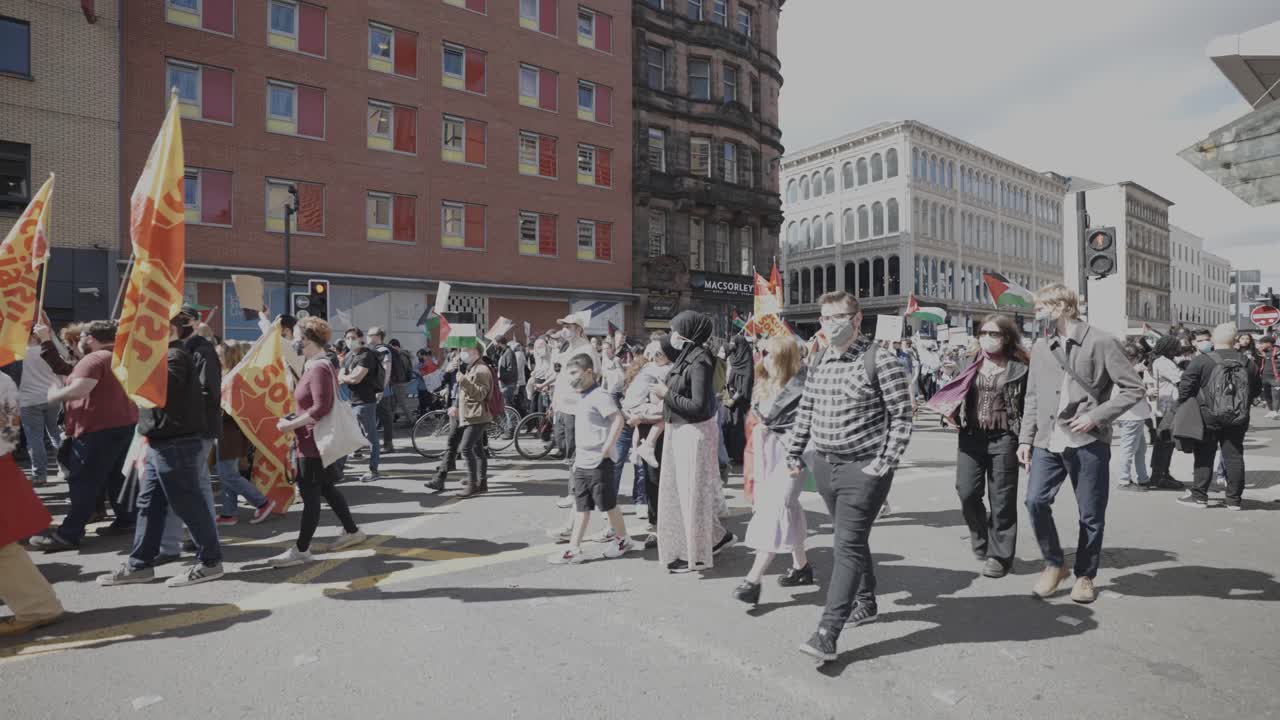 People marching in a pro-Palestine demonstration on a city street