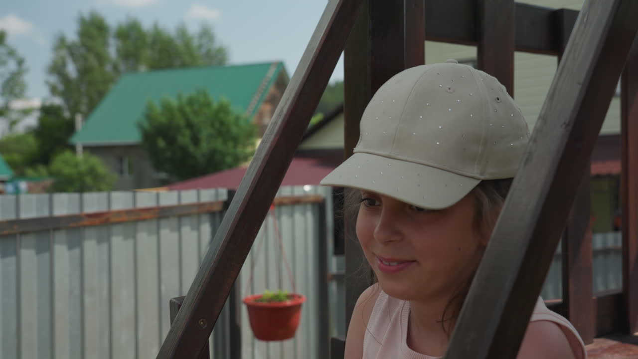 Woman Relaxing Outdoors, Child Woman Resting On Ladder, Young Woman Takes Moment Of Peace Outside Among Greenery, Peaceful Scene Of Woman Pausing During Outdoor Activities On Wooden Ladder