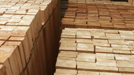 wood boards stacked on shelves in lumber yard ready for sale. wood raw materials