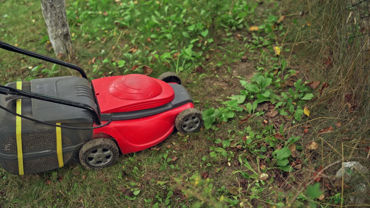 Lawn mowing in the garden. Man cutting grass in his yard with lawn mower