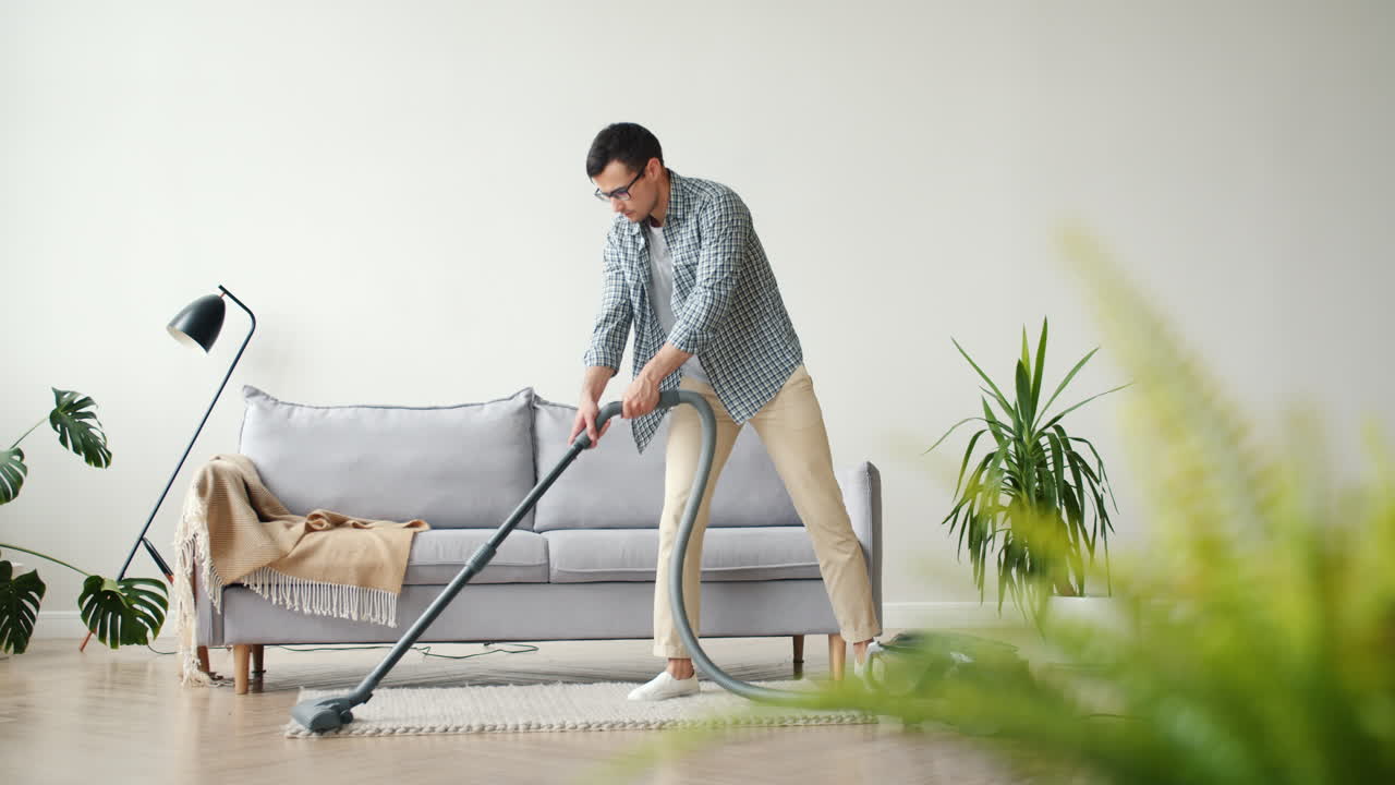 Man Vacuuming a Living Room