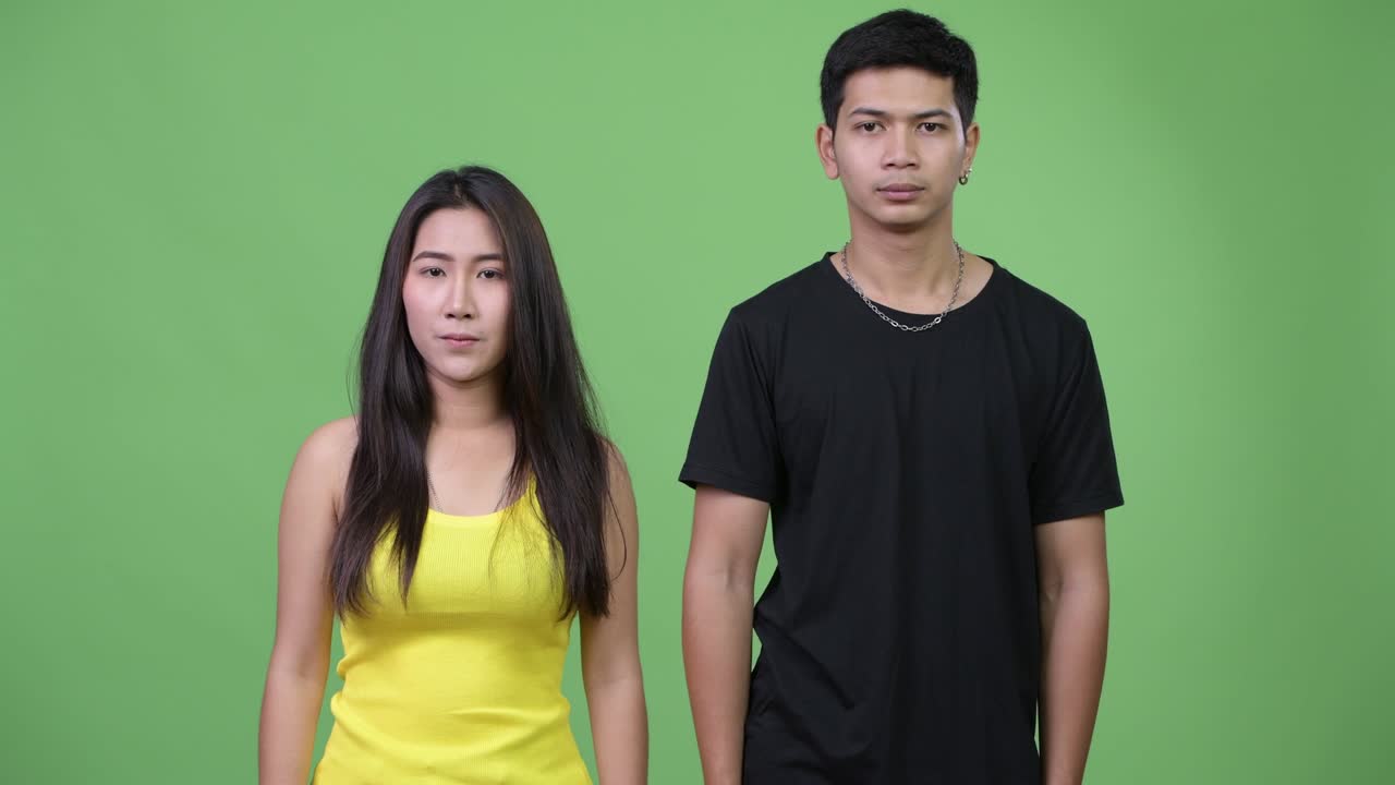 Young Asian couple giving handshake together