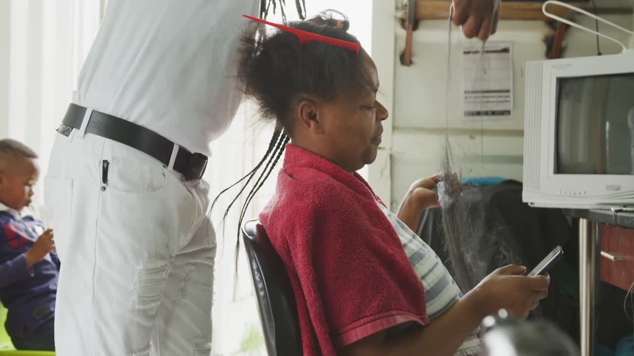 African man adding hair extensions
