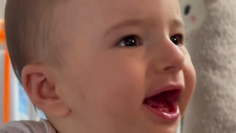 Closeup-frustrated-Caucasian-baby-boy-in-his-playpen,-tired-wants-attention-of-parents