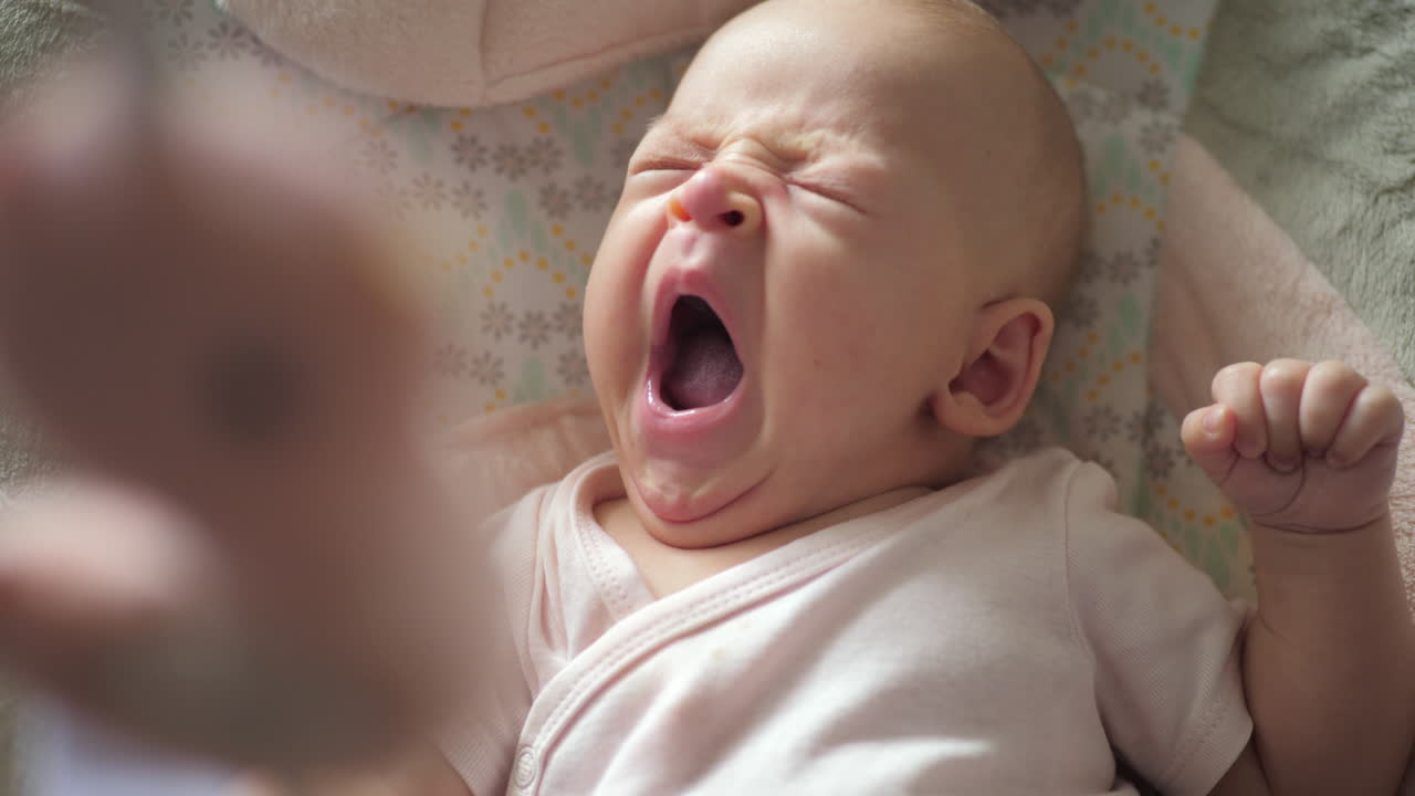 A slow motion of a yawning baby girl