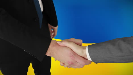 animation of caucasian business people shaking hands over flag of ukraine