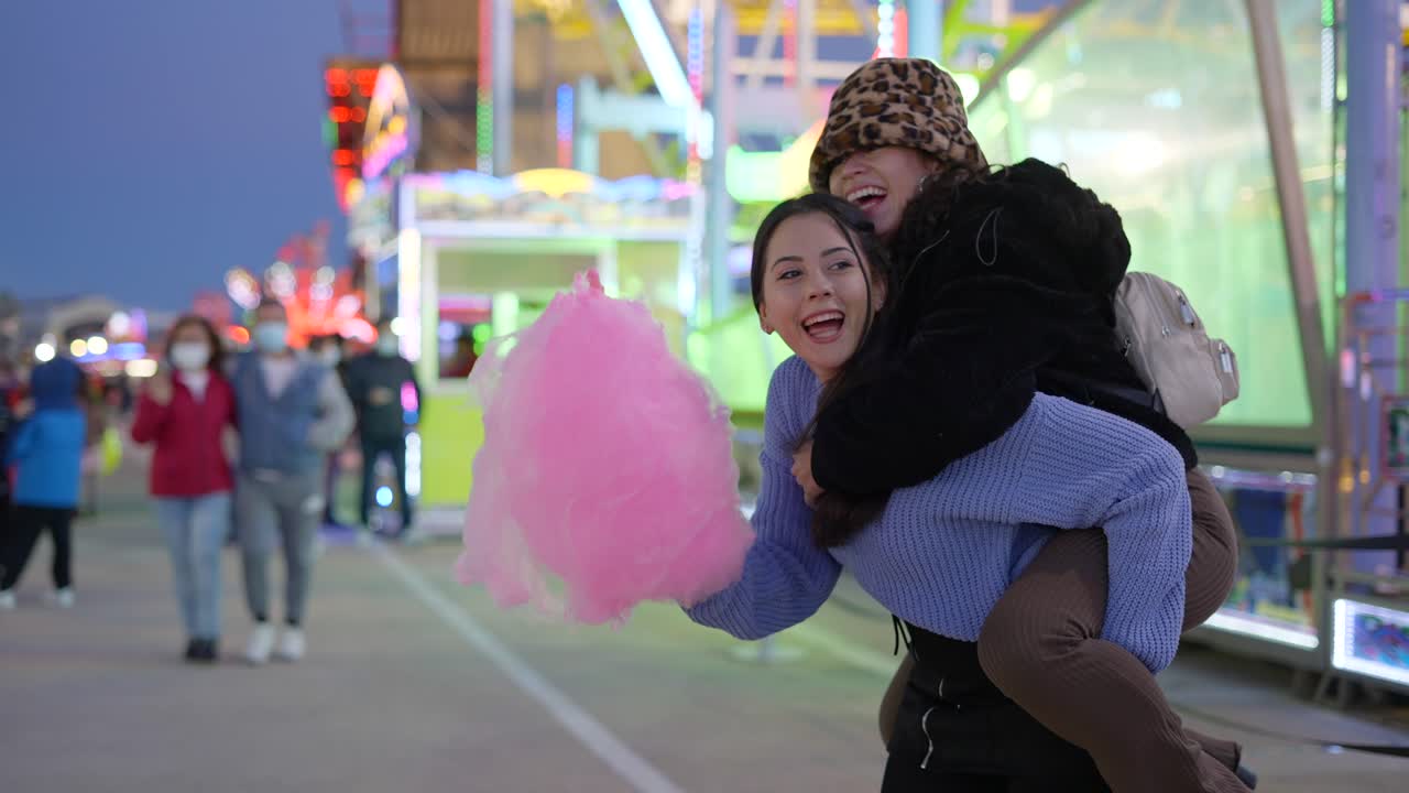 Friends Enjoying Cotton Candy at a Night Fair