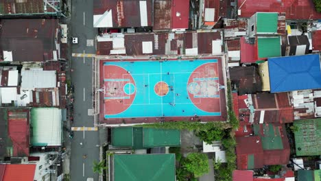 drone top down perspective of people playing basketball in quezon city philippines, street court