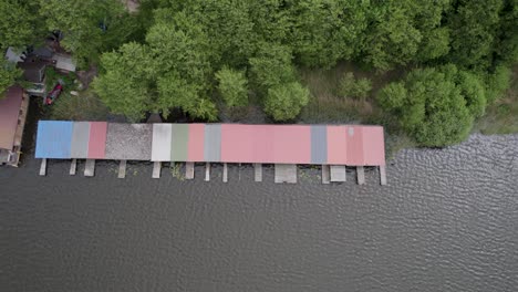 Top-down-shot-of-huts-by-the-lakeside-of-Lake-Mirow-in-Germany