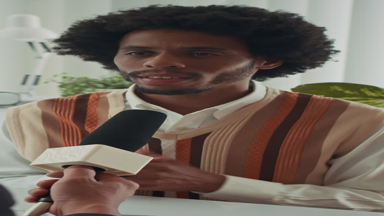 Black Male Entrepreneur Giving Interview to Journalist at Office