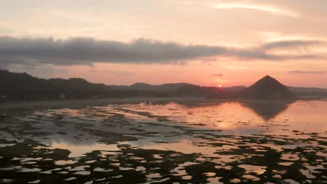 The-dry-reef-of-Kuta-Lombok-during-sunrise,-with-local-people-looking-for-food-and-seashells