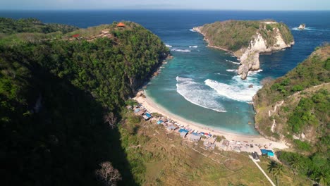 Antena-Descendente-Hacia-La-Playa-De-Atuh-Con-Vistas-A-La-Isla-Batupadasan-En-Nusa-Penida,-Bali,-Indonesia