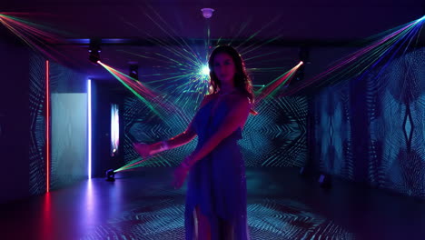 woman dancing amidst laser lights and neon patterns