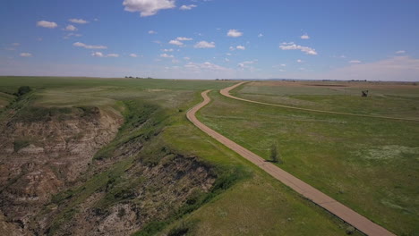 4K-Vegetation-and-road-in-Drumheller,-Alberta,-Canada---Windy-day,-Aerial