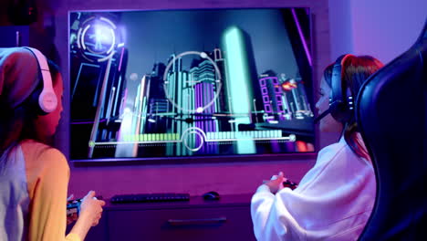 playing video game, two teenage girls wearing headsets and enjoying together