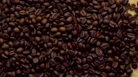 4k footage. 4096x2304p.fragrant coffee beans are roasted in a frying pan, smoke comes from coffee beans. the whole composition scrolls slowly around the camera. scoop stir coffee beans.