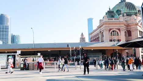 people walking outside flinders street railway station