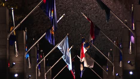 the camera pans up the avenue of flags to mt rushmore at night in lights