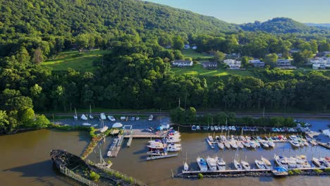 aerial drone footage of the cornwall on hudson waterfront during summer as seen from the hudson river, with the appalachian mountains in the background