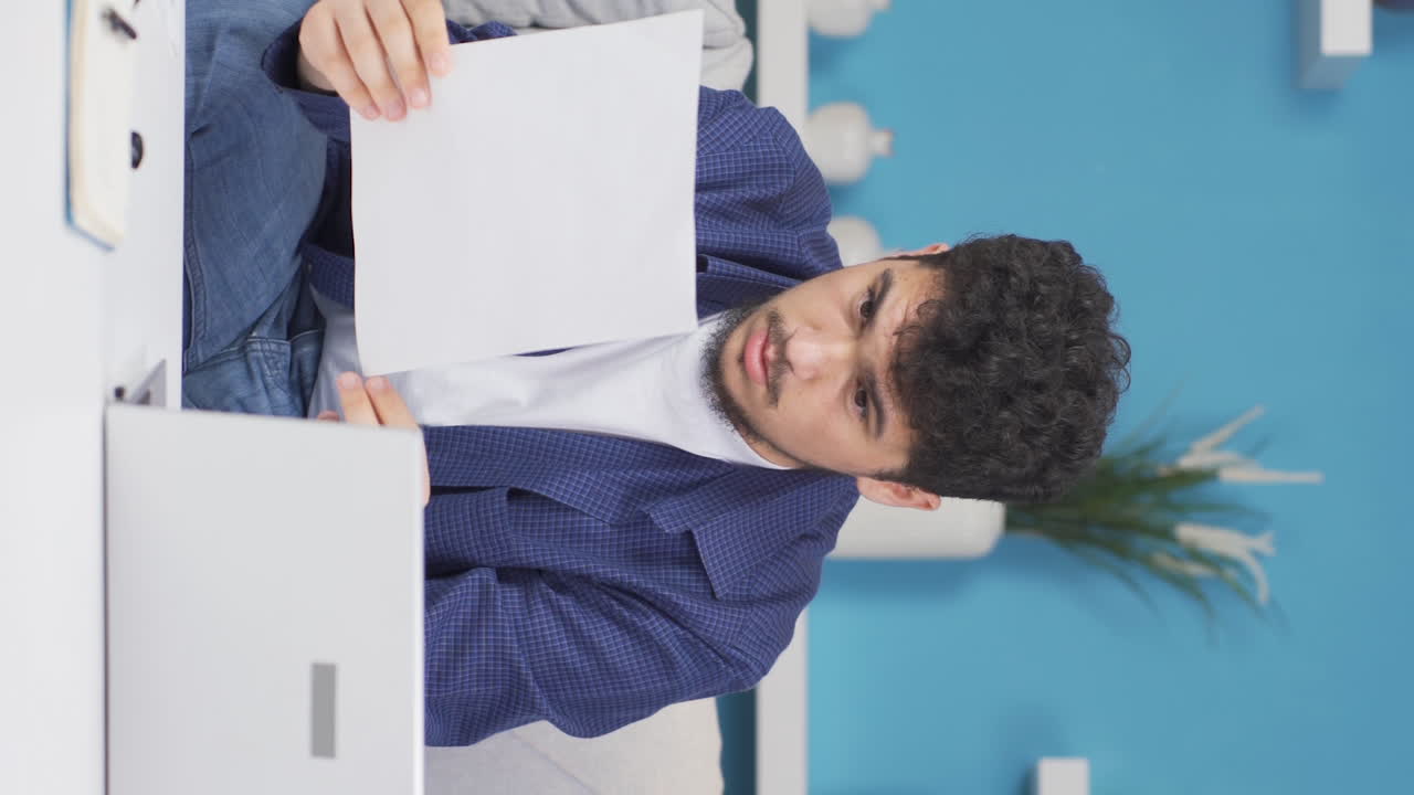 Vertical video of The man who rejoices in good content paperwork.