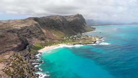 version two. aerial shot over makapu'u beach and makapu'u lookout with beautiful ocean, clouds and cliffs in oahu, hawaii