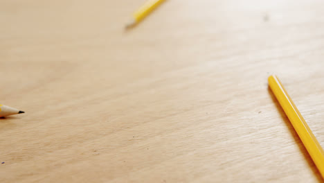 yellow colored pencils on wooden table