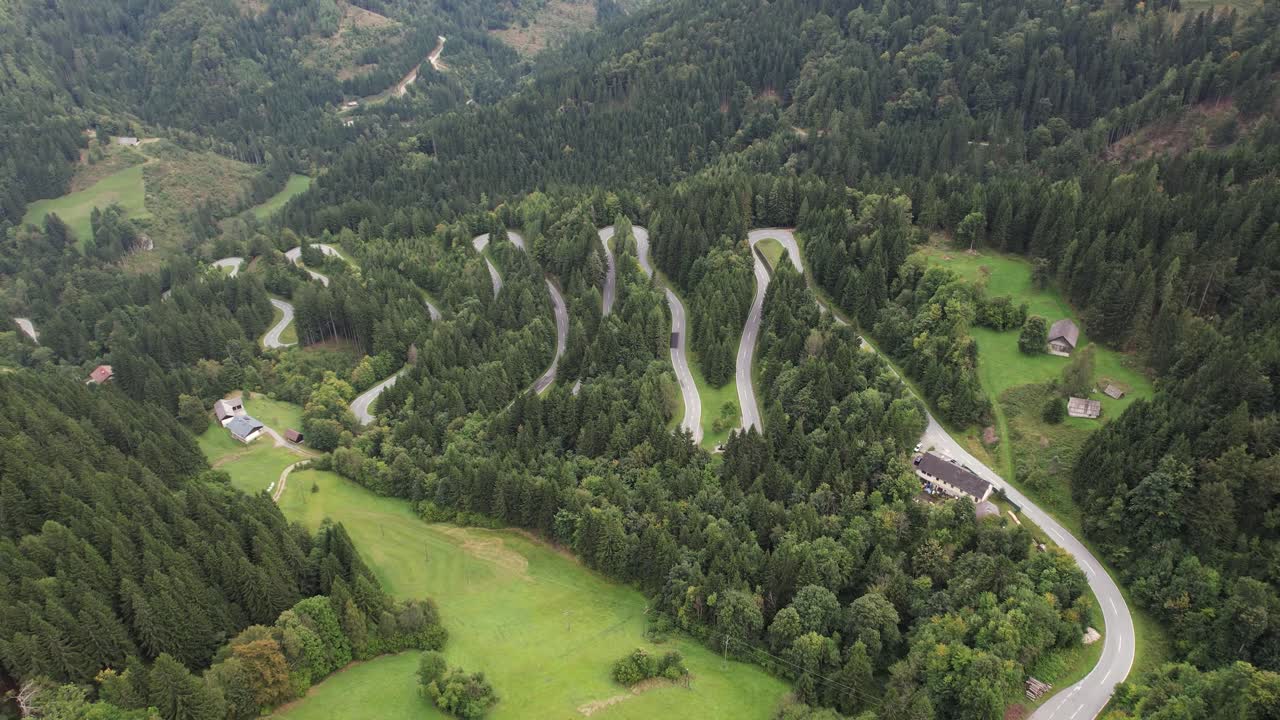 Aerial View of Winding Serpentine Road passing Through Nature in the Austrian Alps, Beautiful Mountain Alpine Pass near Austrian Slovenian Borders