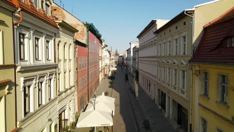 vuelo de drones hacia adelante entre casas antiguas en el casco antiguo de bydgoszcz durante el día de verano en polonia