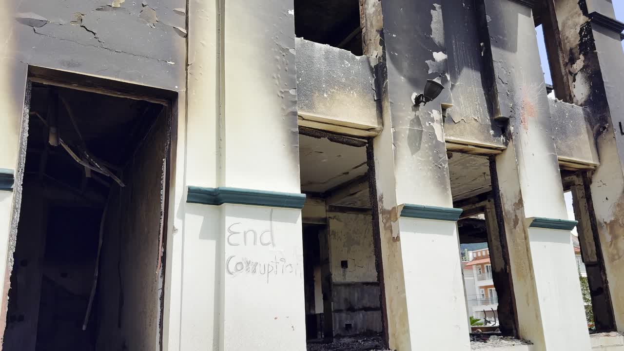During Gen Z protests in Kathmandu on Sept 9, 2025, a burned house bearing the slogan “Enough is Enough” became a powerful symbol of frustration against corruption and government failures